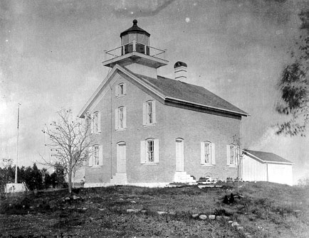 Pilot Island Lighthouse standing alone on its rock in the Death's Door channel